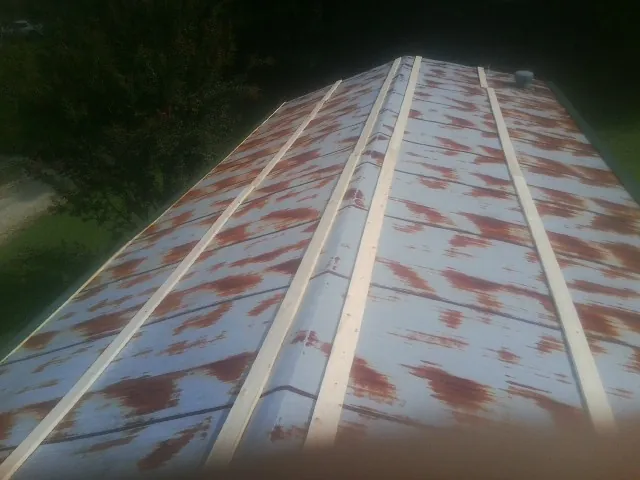 Rusted metal roof panels with new wood purlins before replacement — Storm Damage Roof Repair in Tuckahoe by Roofing Brothers