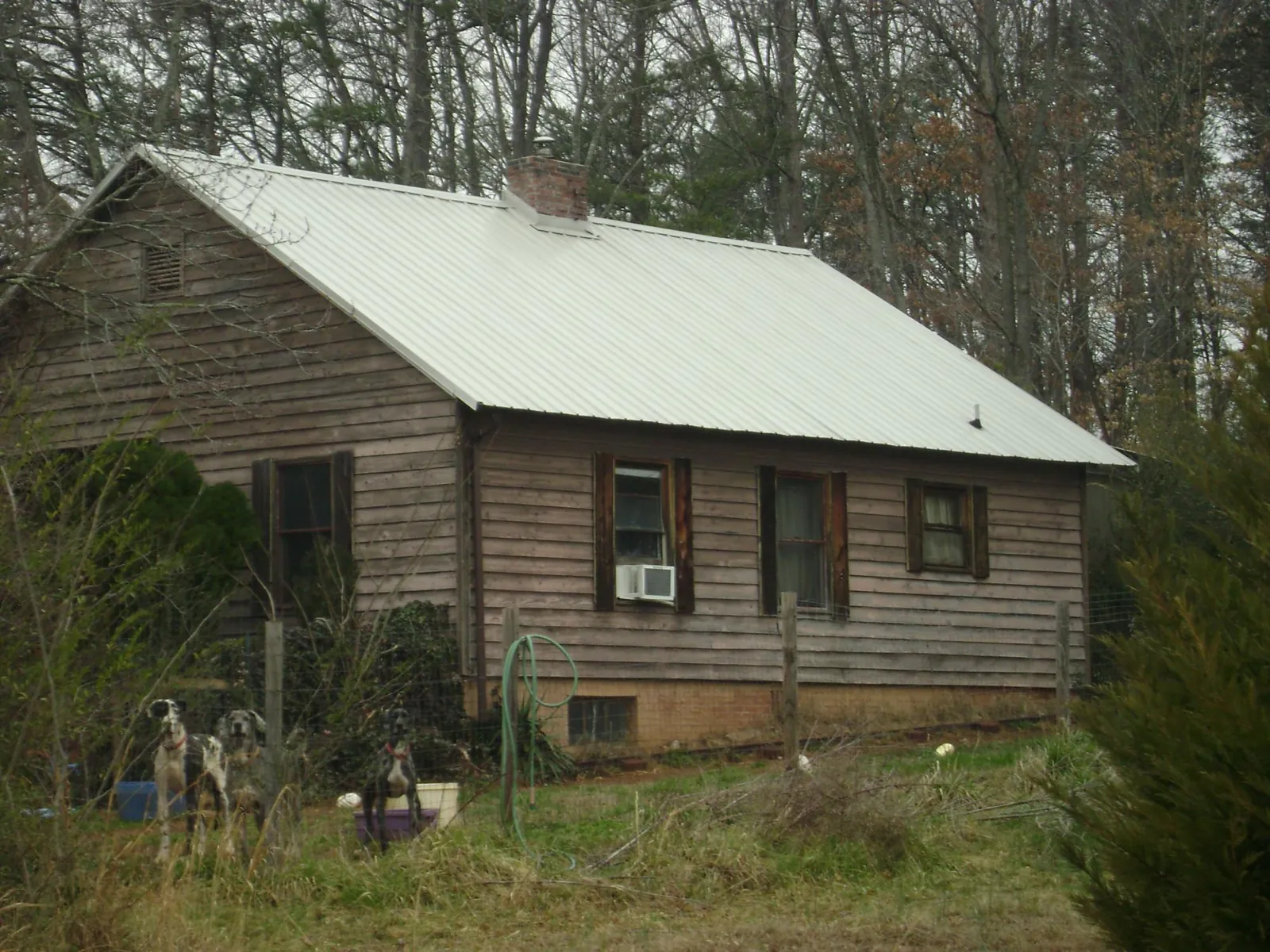 White metal roof on an old wood sided farmhouse, from a Metal Roof Installation job in Tuckahoe